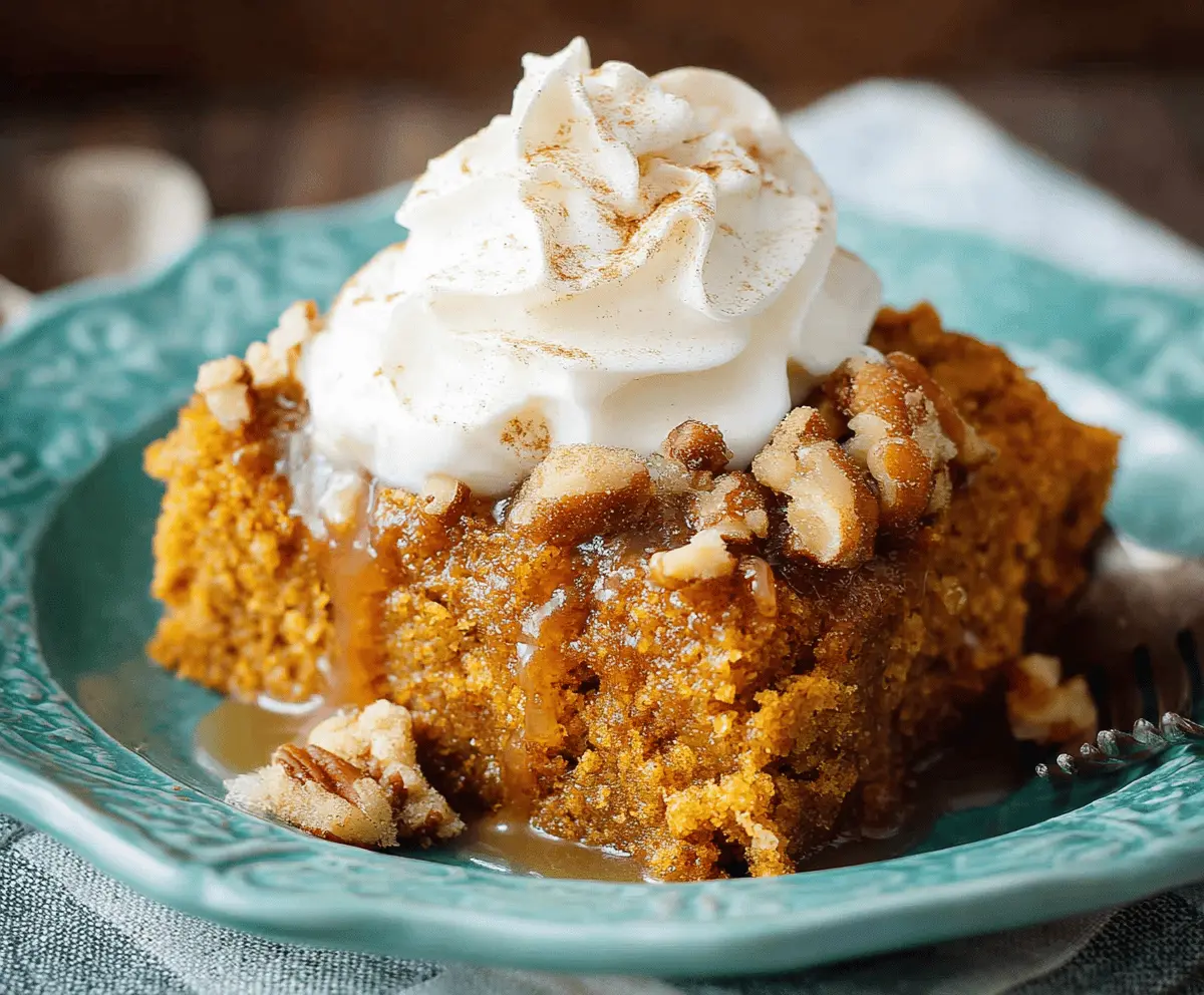 Delicious classic Crockpot pumpkin spice cake topped with whipped cream and cinnamon, perfect for fall dessert