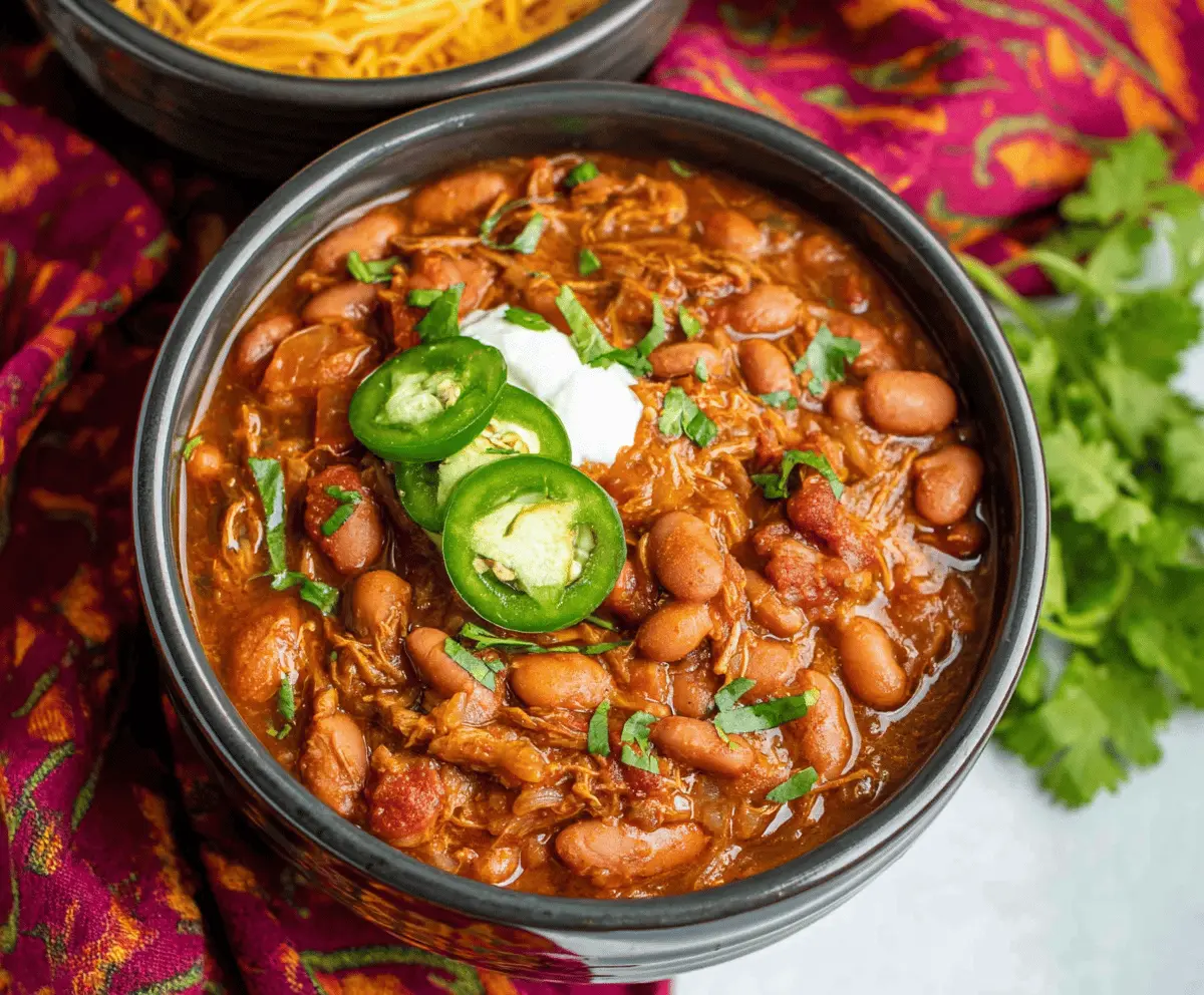 Delicious slow cooker charro beans in a bowl with fresh toppings, perfect for a hearty Mexican-style meal