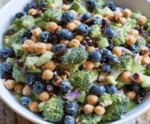 Fresh broccoli, vibrant blueberries, and chickpeas in a colorful broccoli blueberry salad with a light dressing