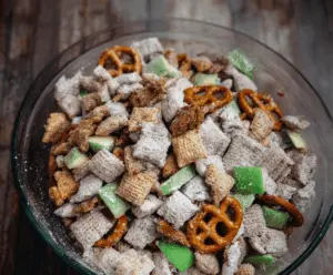 Delicious easy caramel apple puppy chow recipe with colorful apple pieces, chocolate coating, and crunchy cereal in a serving bowl