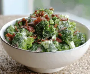 Fresh and vibrant low-carb broccoli salad with cherry tomatoes, bacon bits, and a creamy dressing, perfect for healthy eating.