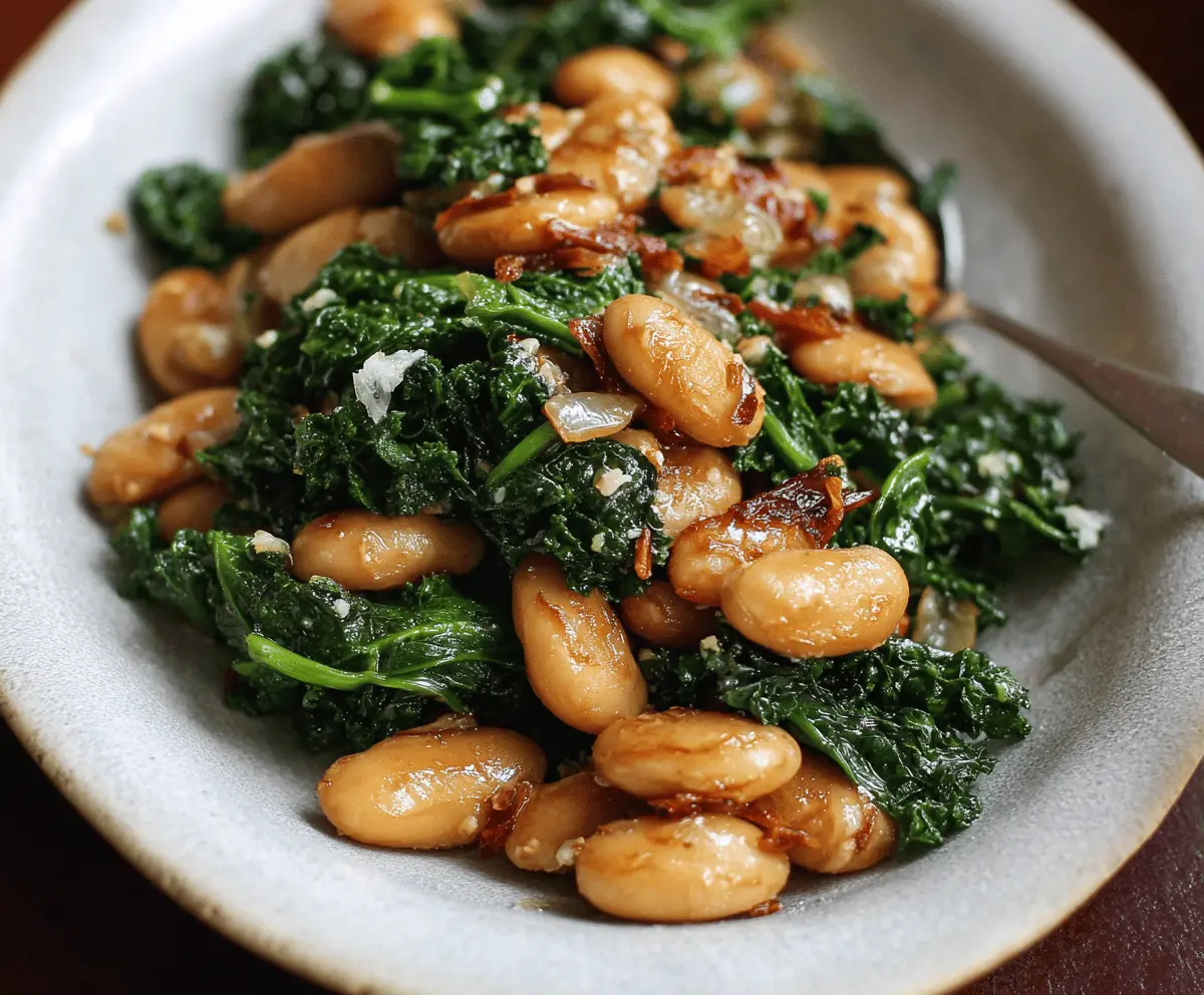 Delicious pan-fried beans with fresh kale served on a plate, showcasing a healthy and colorful vegetarian dish