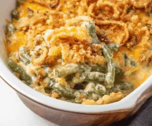 Delicious Cheddar Bay Green Bean Casserole topped with melted cheese and crispy green beans, perfect for a holiday meal.