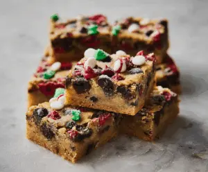 Delicious Christmas Blondies garnished with festive sprinkles on a holiday plate