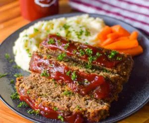 Delicious crockpot Dr. Pepper meatloaf served on a plate with vegetables