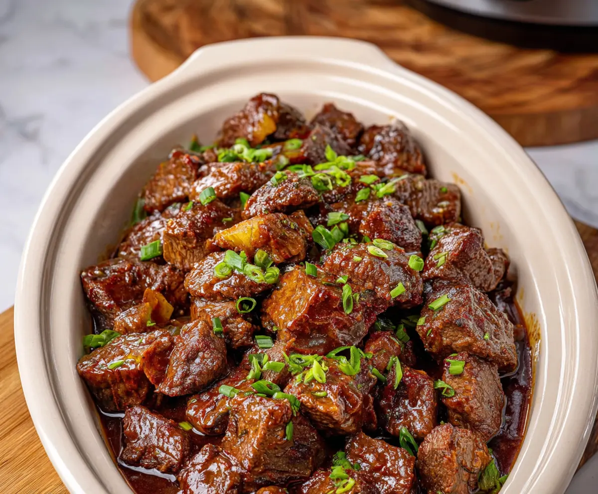 Delicious Crockpot Mississippi Steak Bites served in a bowl with fresh herbs