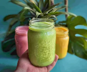 Colorful Tropical Vibes Smoothie with fresh pineapple, mango, and coconut in a glass, garnished with mint.