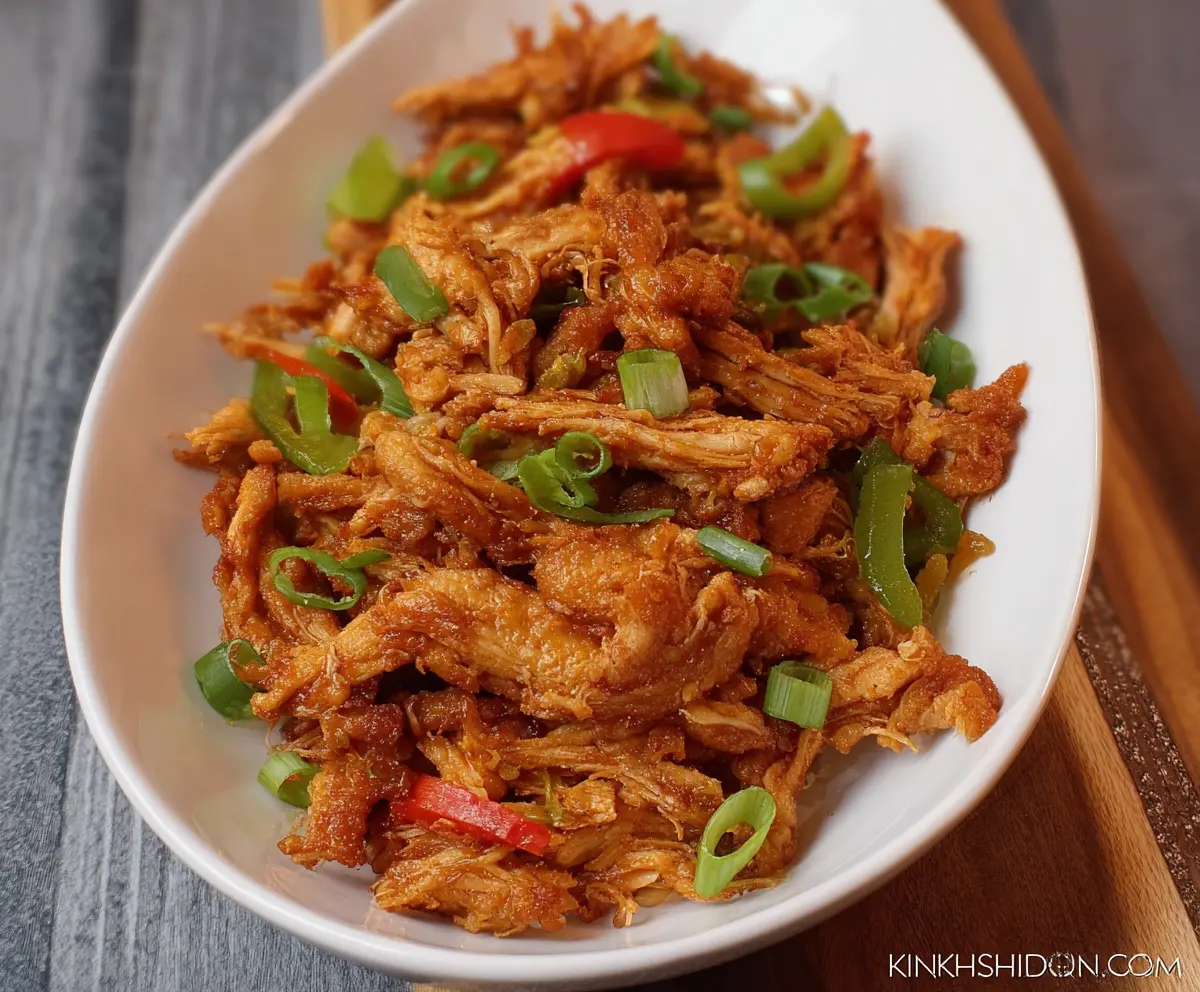 Delicious crispy shredded chicken served on a white plate, perfect for healthy meals and snacks.