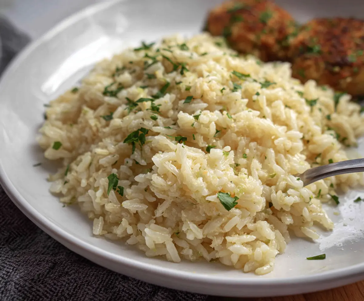 Delicious garlic Parmesan rice served in a bowl, showcasing a flavorful and savory side dish.