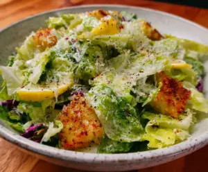 Fresh Nana's Crunchy Lemon Parmesan Salad with vibrant greens, lemon slices, and grated Parmesan cheese.