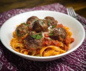 Delicious homemade pasta with savory meatballs and rich tomato sauce.