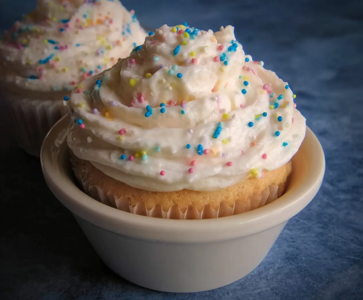 Delicious homemade buttercream icing in a piping bag, perfect for cakes and cupcakes.